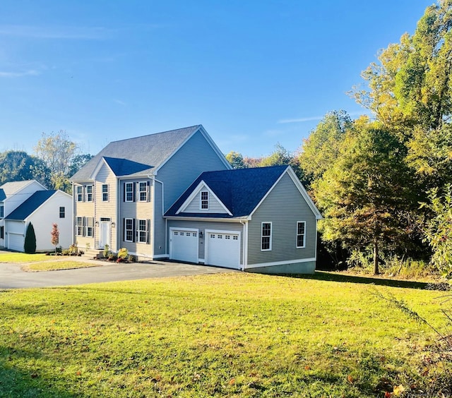 view of front of home featuring a garage and a front lawn