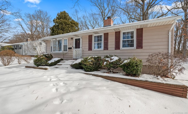 view of front of home featuring a chimney