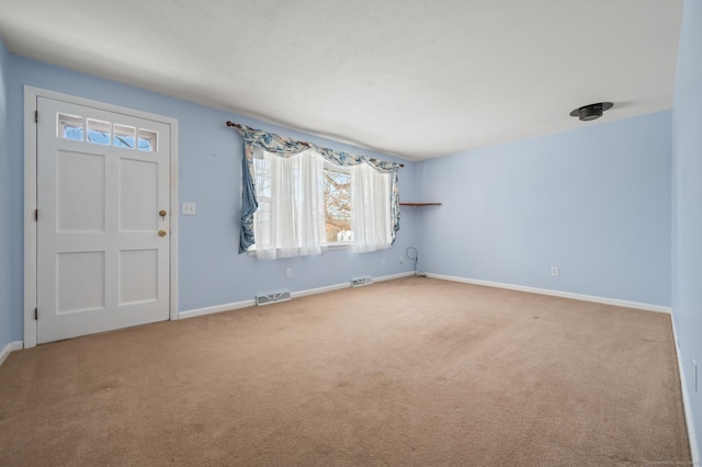 foyer entrance featuring carpet flooring, visible vents, and baseboards