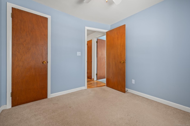 unfurnished bedroom featuring carpet floors, ceiling fan, and baseboards