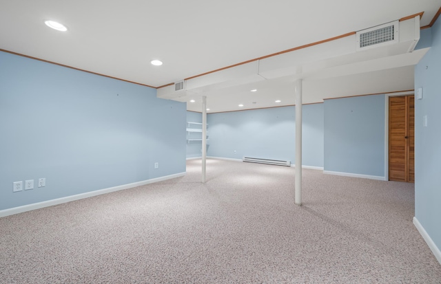 finished below grade area featuring carpet floors, a baseboard radiator, visible vents, and recessed lighting