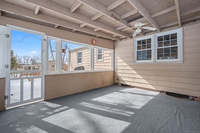 unfurnished sunroom with a ceiling fan