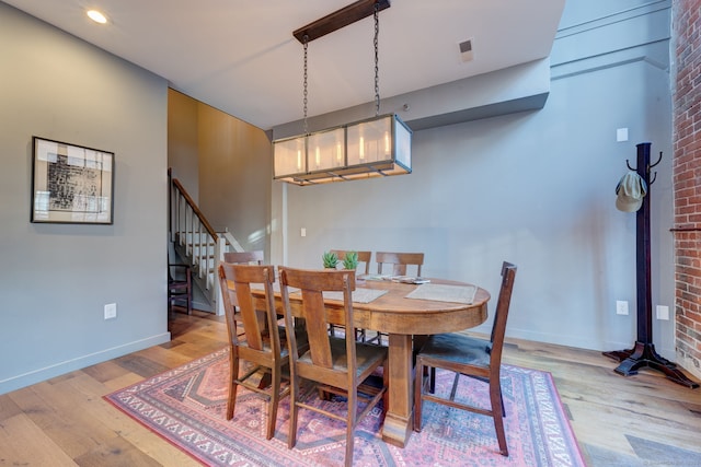 dining space with light hardwood / wood-style floors