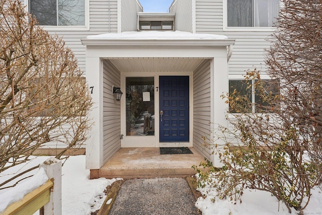 view of snow covered property entrance