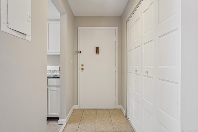 doorway to outside featuring light tile patterned flooring