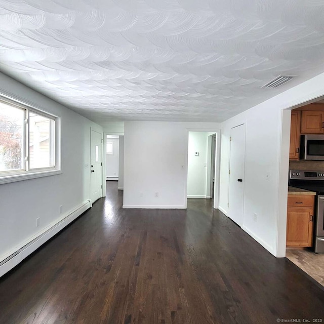 unfurnished living room featuring a baseboard heating unit, a textured ceiling, and dark hardwood / wood-style flooring