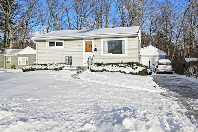 view of front of property with an outbuilding and a detached garage