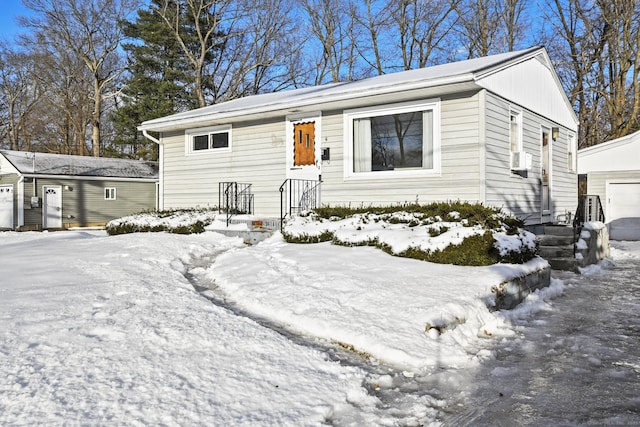 single story home with an outbuilding and a detached garage