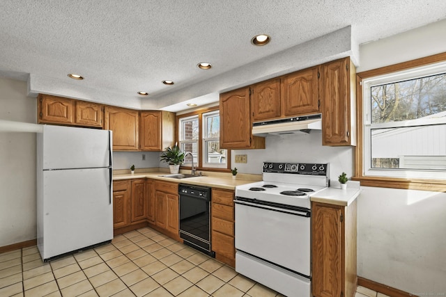 kitchen with light countertops, brown cabinetry, a sink, white appliances, and under cabinet range hood