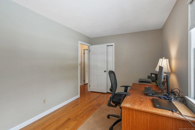 home office with hardwood / wood-style flooring