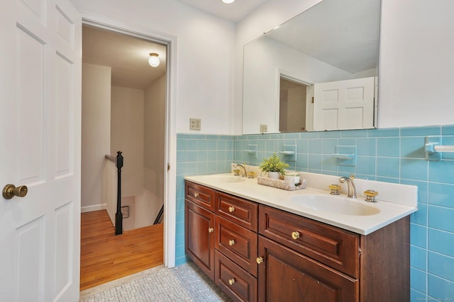 bathroom featuring vanity, tile patterned flooring, and tile walls