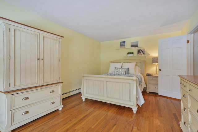 bedroom featuring a baseboard radiator and light wood-type flooring