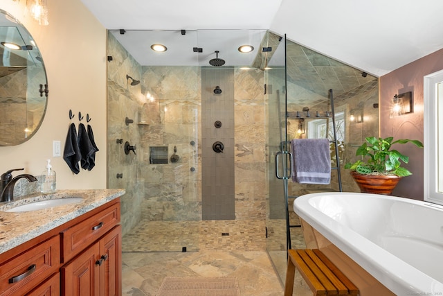 bathroom with vanity and separate shower and tub