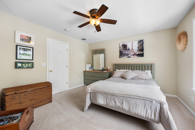 bedroom with ceiling fan and light carpet