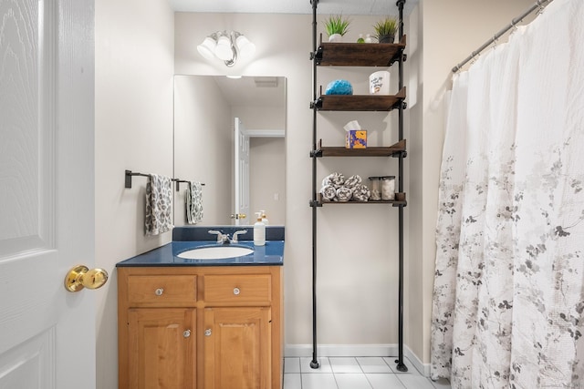 bathroom with a shower with curtain, tile patterned floors, and vanity