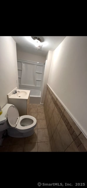 full bathroom featuring tile patterned flooring, vanity, tub / shower combination, and toilet