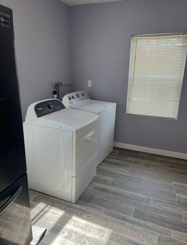 clothes washing area with washing machine and dryer