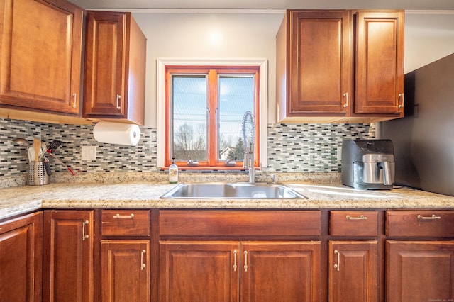 kitchen featuring tasteful backsplash and sink