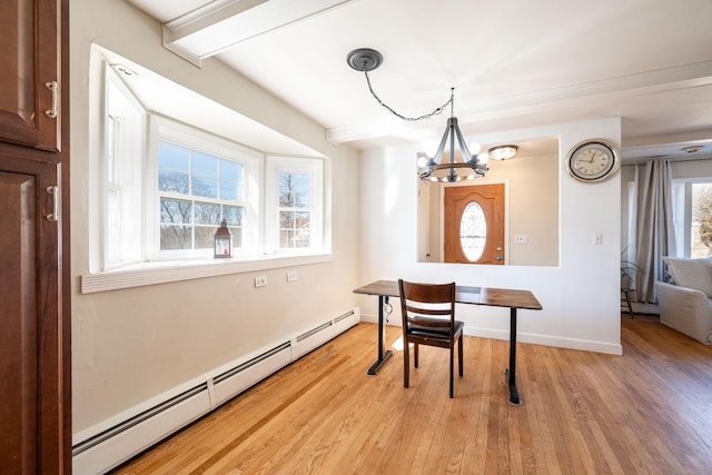 dining room featuring light wood-type flooring, a chandelier, and baseboard heating