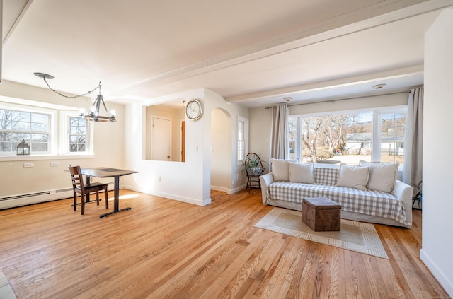 living room with an inviting chandelier and light wood-type flooring