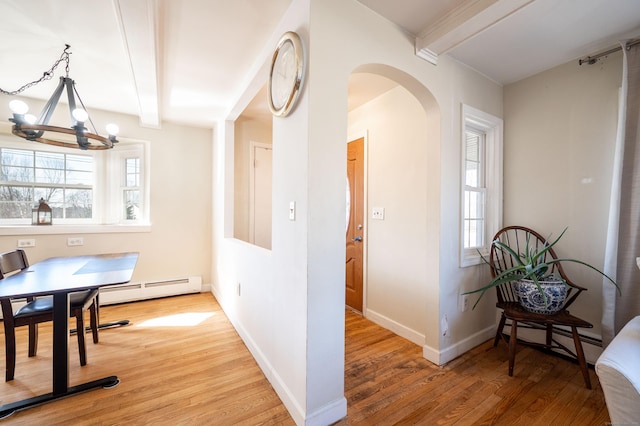 hallway with beamed ceiling, a baseboard radiator, wood-type flooring, and a chandelier