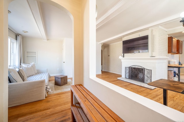 living room with hardwood / wood-style floors and beam ceiling