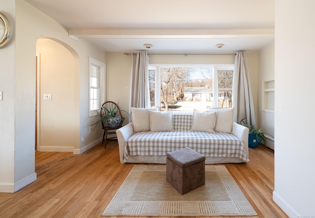 living area featuring a baseboard heating unit and light wood-type flooring