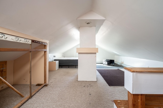 additional living space featuring light carpet and lofted ceiling