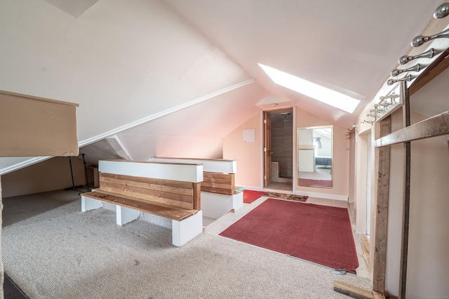 additional living space with carpet floors and vaulted ceiling with skylight