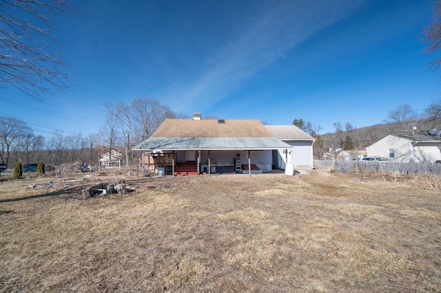 rear view of house with a yard