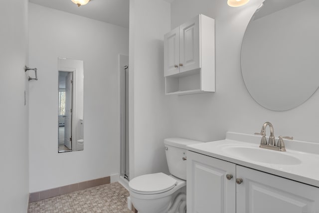 bathroom with vanity, an enclosed shower, and toilet