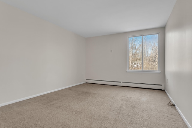 carpeted empty room featuring a baseboard heating unit