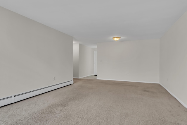 empty room featuring baseboard heating and light carpet