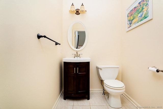 bathroom with tile patterned flooring, vanity, and toilet