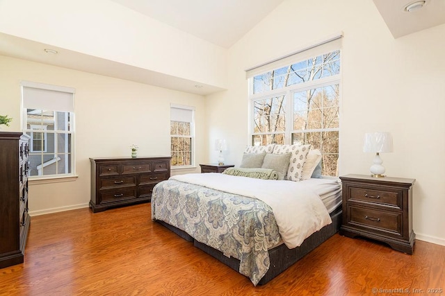 bedroom featuring vaulted ceiling and dark wood-type flooring