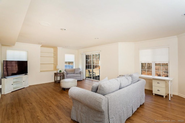 living room with hardwood / wood-style flooring and crown molding