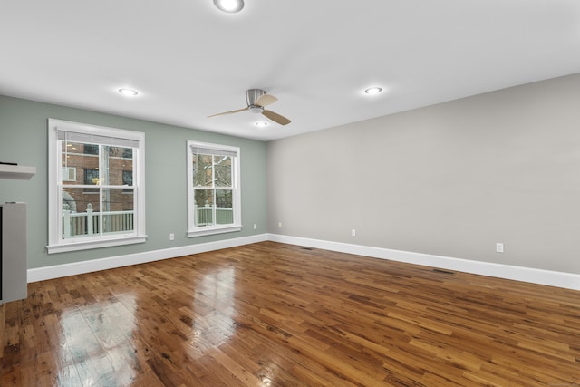 empty room featuring hardwood / wood-style flooring and ceiling fan