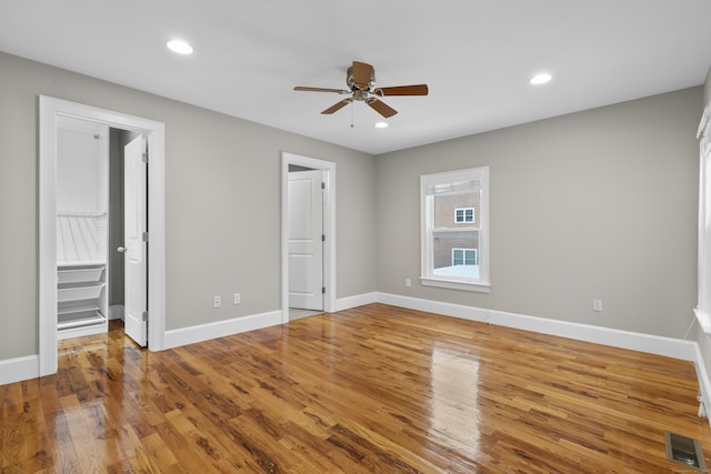 interior space with wood-type flooring and ceiling fan