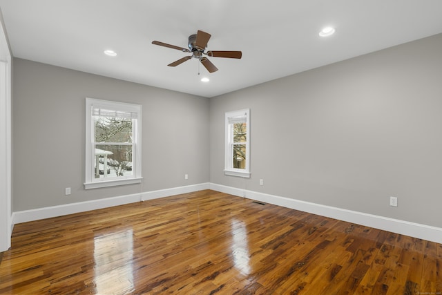 spare room featuring wood-type flooring and ceiling fan