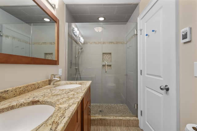 bathroom featuring vanity, toilet, and a shower with shower door