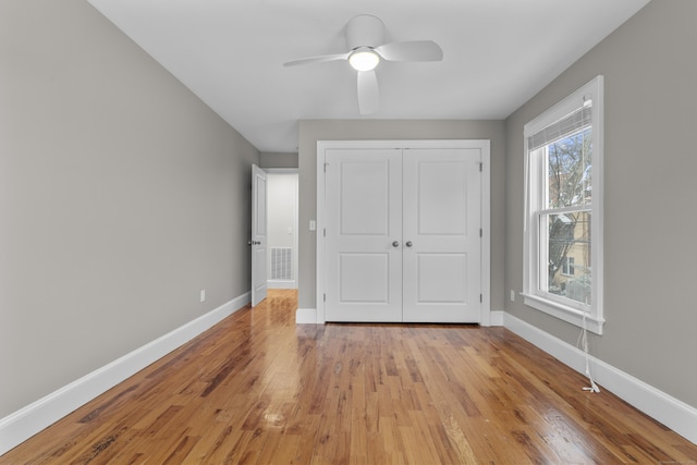 unfurnished bedroom with a closet, ceiling fan, and light wood-type flooring