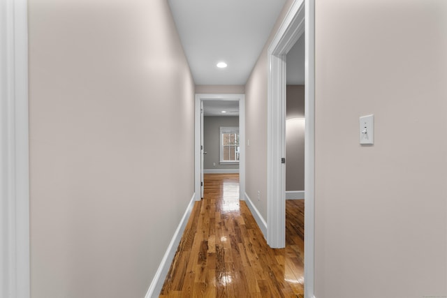 hallway with hardwood / wood-style flooring