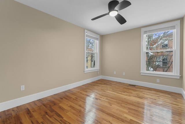 empty room featuring ceiling fan and light wood-type flooring