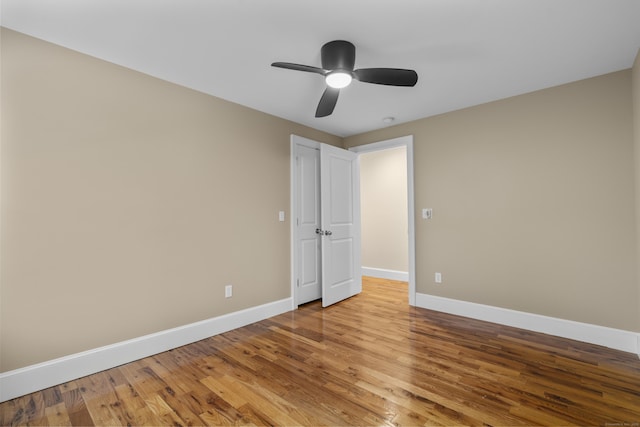 unfurnished bedroom with ceiling fan and light wood-type flooring