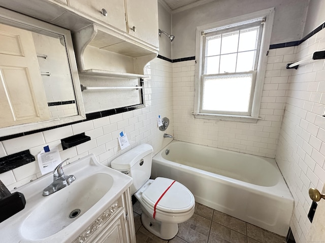 full bathroom featuring tile walls, tile patterned flooring, tiled shower / bath combo, vanity, and toilet