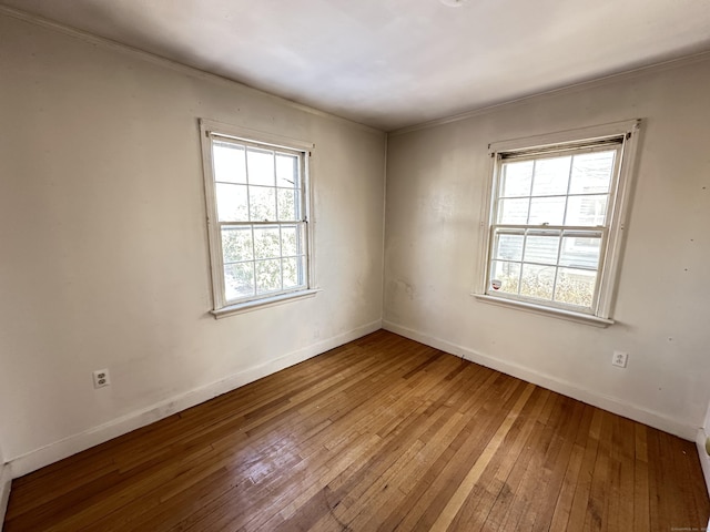 unfurnished room with hardwood / wood-style flooring