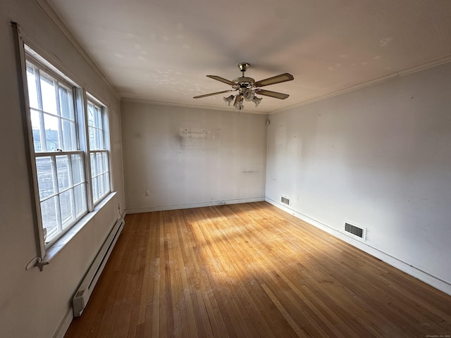 spare room with crown molding, a baseboard heating unit, ceiling fan, and light hardwood / wood-style floors