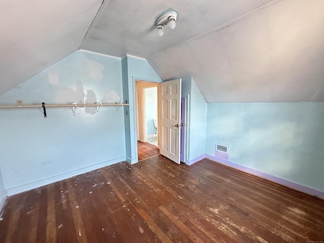 bonus room featuring vaulted ceiling and dark hardwood / wood-style floors