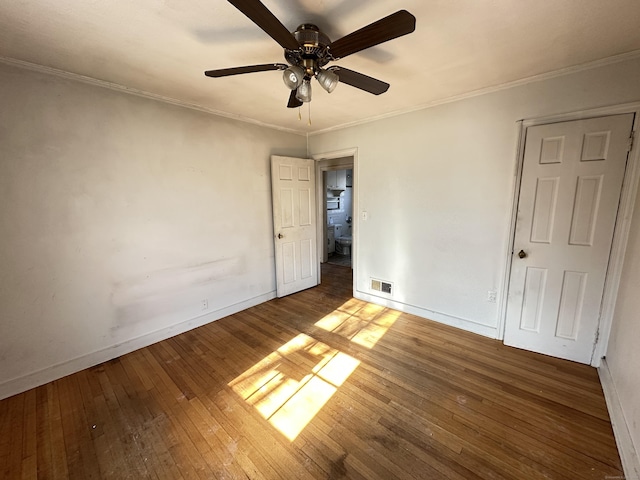 unfurnished bedroom with crown molding, wood-type flooring, and ceiling fan