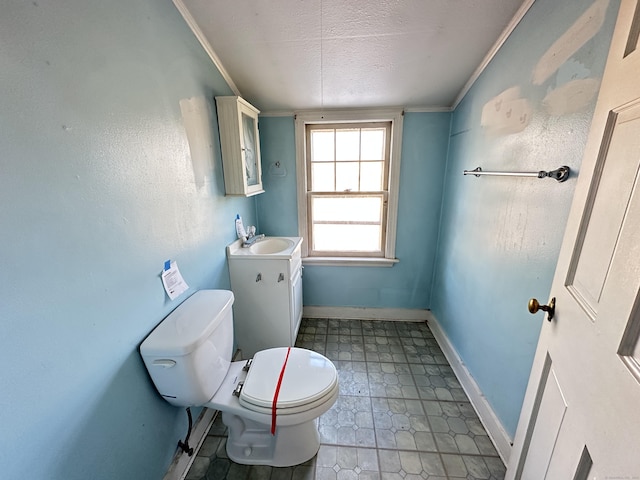 bathroom featuring vanity, crown molding, a textured ceiling, and toilet